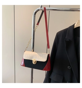 Detail of tricolor baguette bag with white croc texture and golden rotary lock
