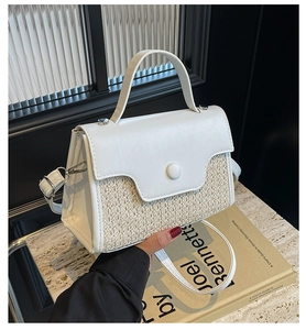 Detail showing white PU leather and beige woven straw texture on a crossbody bag
