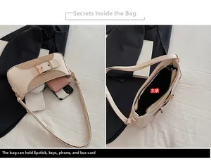 Detail view of contrast color underarm bag interior showing large capacity and structure