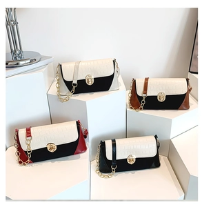 Close-up of four luxury crocodile pattern shoulder bags with gold rotating metal buckles
