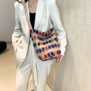 Rainbow plush tote bag with colorful pom-poms on beige fleece texture, casual shoulder bag