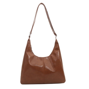 Brown vintage faux leather tote bag with a glossy finish and long shoulder strap