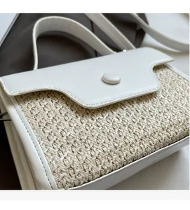 Close-up of a stylish white leather and beige woven straw small square handbag for women