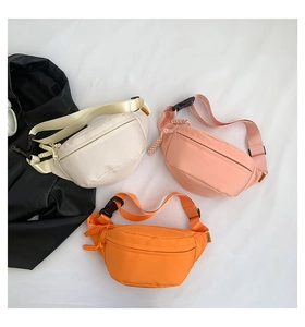 Waterproof nylon waist bags in cream, pink, and orange with woven zipper pulls