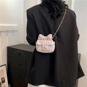 Mini colorful tweed crossbody bag with bow decoration and gold chain strap on model