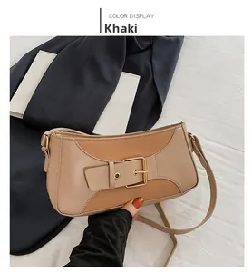 Detail of khaki and brown patchwork shoulder bag with metal buckle belt accessory