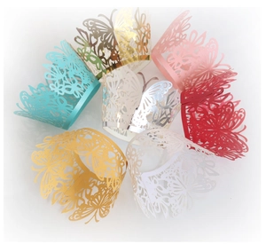 Detail view of seven-color laser-cut butterfly cupcake wrappers with pearlescent finish