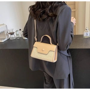 Detailed view of the beige woven crossbody bag with leather flap and adjustable strap