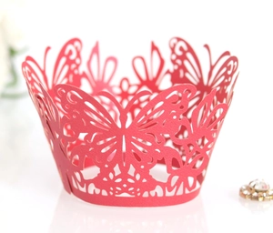 Close-up of laser-cut butterfly cupcake wrappers in vibrant red paper finish