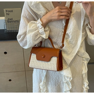 Detail of vintage patchwork woven small square bag with brown leather flap and handle