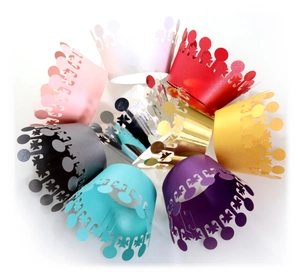 Laser-cut crown cupcake wrappers in multiple vibrant colors for party decorations