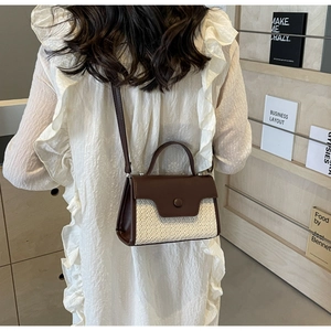 Detail showing woven texture and dark brown leather flap with round button closure