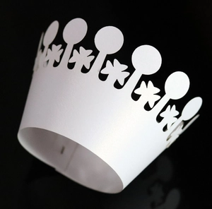Detailed laser-cut white crown cupcake wrapper with elegant hollow lace pattern