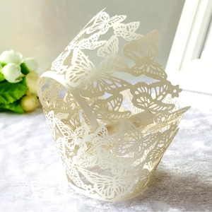 Elegant ivory laser-cut butterfly cupcake wrappers for wedding table decorations