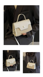 Detail of straw patchwork handbag showing adjustable strap and woven texture on white leather