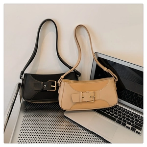 Detail of vintage baguette bags in black and beige with elegant gold buckles