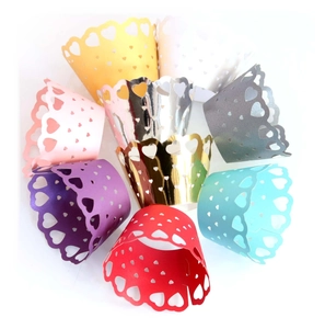Detailed laser cut heart pattern cupcake wrappers in various metallic and matte colors