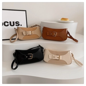 Detailed view of assorted baguette bags with adjustable straps and gold metal buckles