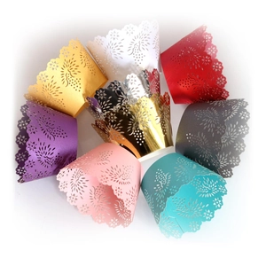 Laser cut floral cupcake wrappers in multiple vibrant colors for party decorations