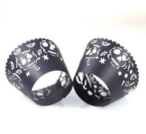 Black laser-cut skull cupcake wrappers for Halloween or Day of the Dead party decor
