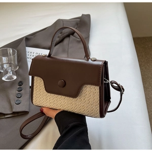 Detail of woven and brown leather texture on a stylish small crossbody bag for women
