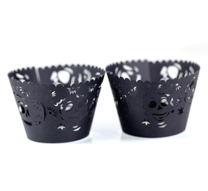 Laser-cut black Halloween cupcake wrappers featuring skull and star hollow patterns