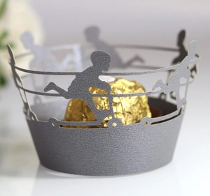 Intricate laser cut cupcake wrapper with boy silhouette pattern in matte dark grey finish