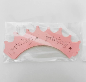 Pink crown laser-cut cupcake wrappers with Princess text and star patterns in packaging