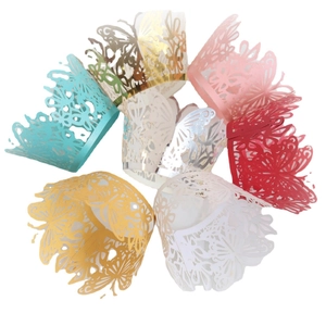 Laser cut butterfly cupcake wrappers in various pearlescent colors for wedding decor