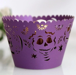 Close-up of purple laser-cut cupcake wrapper with skull and star patterns for Halloween