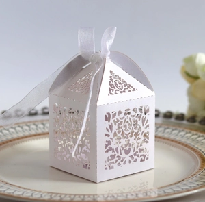 Laser cut white paper gift box with floral hollow patterns and white satin ribbon detail