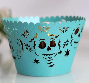 Intricate laser-cut skull and star patterns on a turquoise cupcake wrapper detail
