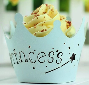 Close-up of light blue crown laser cut cupcake wrapper with princess text and stars