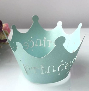 Detail of mint green Prince paper crown with laser-cut edges and white star motifs
