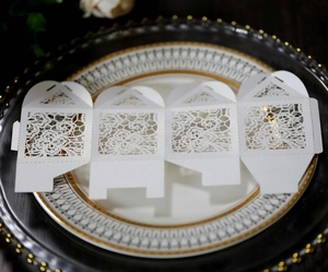 Detailed laser-cut floral pattern on elegant white pearlescent paper wedding candy box