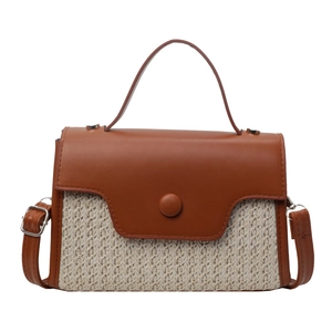 Minimalist woven straw and brown leather small crossbody bag with top handle and magnetic clasp