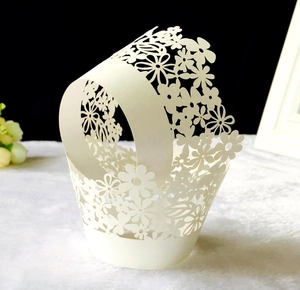 Laser-cut white floral hollow pattern paper cupcake liners for wedding party decorations