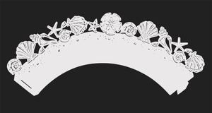 Macro detail of laser cut paper cake wrapper featuring white seashells and starfish pattern