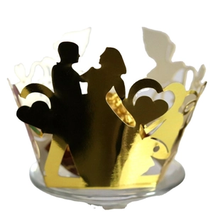 Golden laser cut wedding cupcake wrappers with bride and groom silhouette and hearts