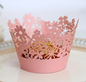 Detail of pink laser-cut floral cupcake wrapper with gold foil chocolate display