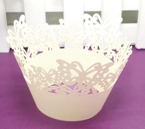 Intricate laser-cut butterfly cupcake wrapper in cream white for wedding party decoration