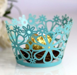 Close-up of light blue laser-cut flower cupcake wrapper with chocolate inside
