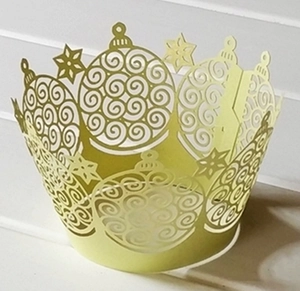 Laser-cut yellow-green Christmas tree cupcake wrappers with star and ornament patterns