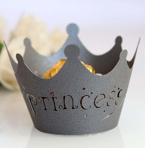 Detail of dark grey crown cupcake wrapper with princess cutout and star patterns