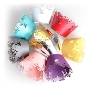 Intricate laser-cut heart pattern cake wrappers in assorted colors for wedding decoration