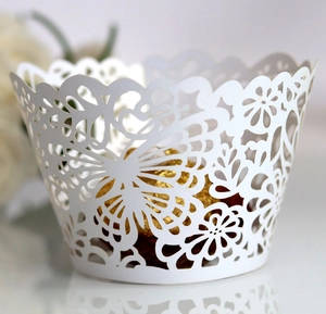 White laser cut cupcake wrappers with butterfly and floral patterns for wedding party decor