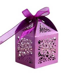 Elegant purple laser-cut wedding favor box with floral patterns and a matching organza ribbon