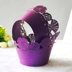 Close-up of purple laser-cut cupcake wrappers with intricate ocean seashell patterns
