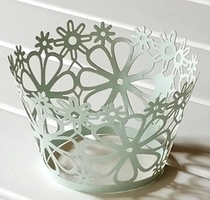 Detailed laser-cut daisy flower cupcake wrapper in light green for party decoration