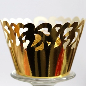 Golden laser-cut cupcake wrappers with heart hollow design and wavy edges for baking